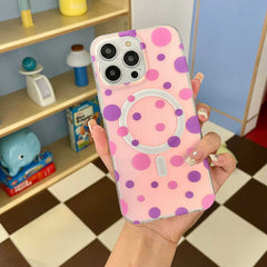 Polka dot magnetic phone case for iPhone with pink and purple design held in hand.