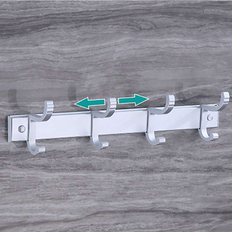Punch free Bathroom coat hooks with four white hooks mounted on a gray tiled wall.