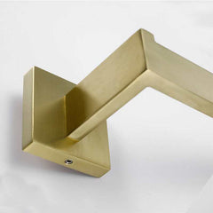 Golden stainless steel wall-mounted hook with a modern design.