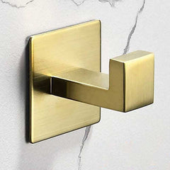 Stainless steel wall-mounted hook in golden finish on white marbled background.