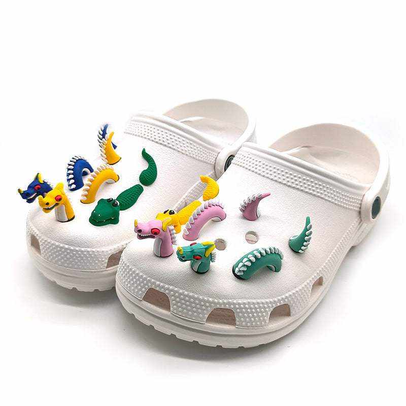 3D dragon shoe buckles as shoe accessories on white clogs.