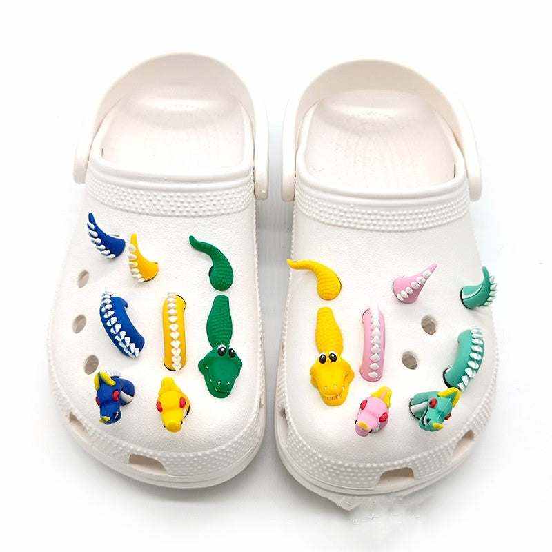 3D dragon-themed shoe accessories on white clogs.