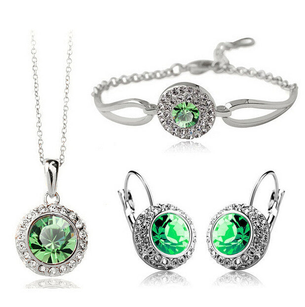 Korean style jewelry set with green crystals in silver alloy, including necklace, bracelet, and earrings.