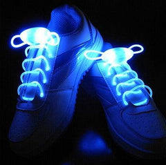 LED sport shoe laces glowing in blue light on sneakers.