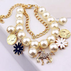 Pearl Flower Bracelet with gold chain and delicate floral charms.