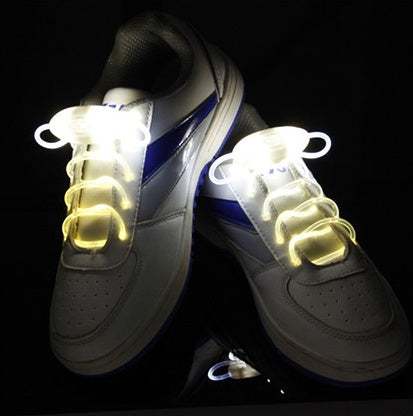 Led Sport Shoe Laces glowing on white sneakers in the dark.