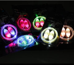 LED sport shoe laces glowing in various colors in the dark.
