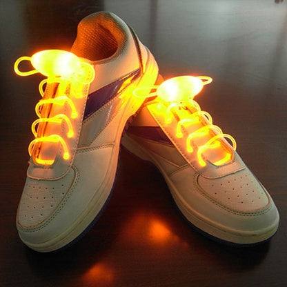 LED sport shoe laces glowing orange on sneakers, enhancing visibility and style.