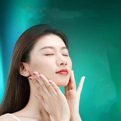 Woman applying plant skin care product for hydrating and brightening effects.