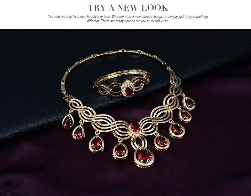 Jewelry Fashion Gems necklace and earrings set with gold alloy and red rhinestones displayed elegantly.
