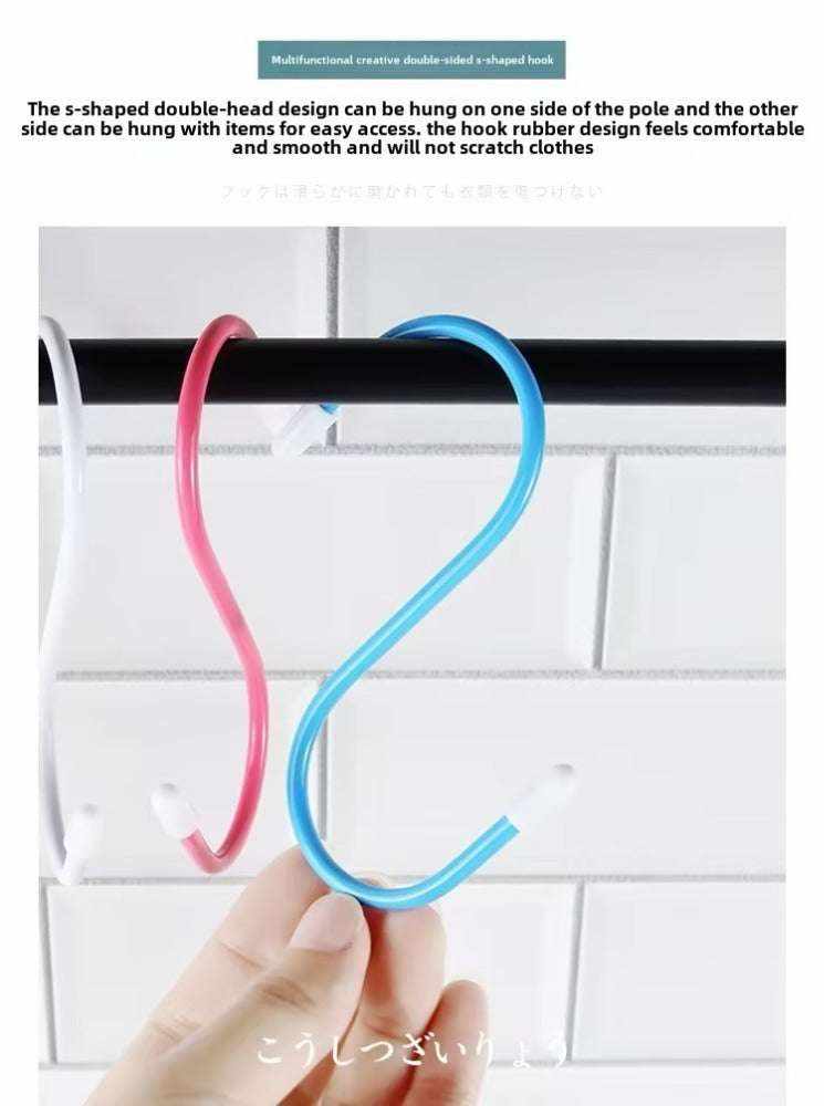 4 colorful rubber S-hooks hanging on a rod.