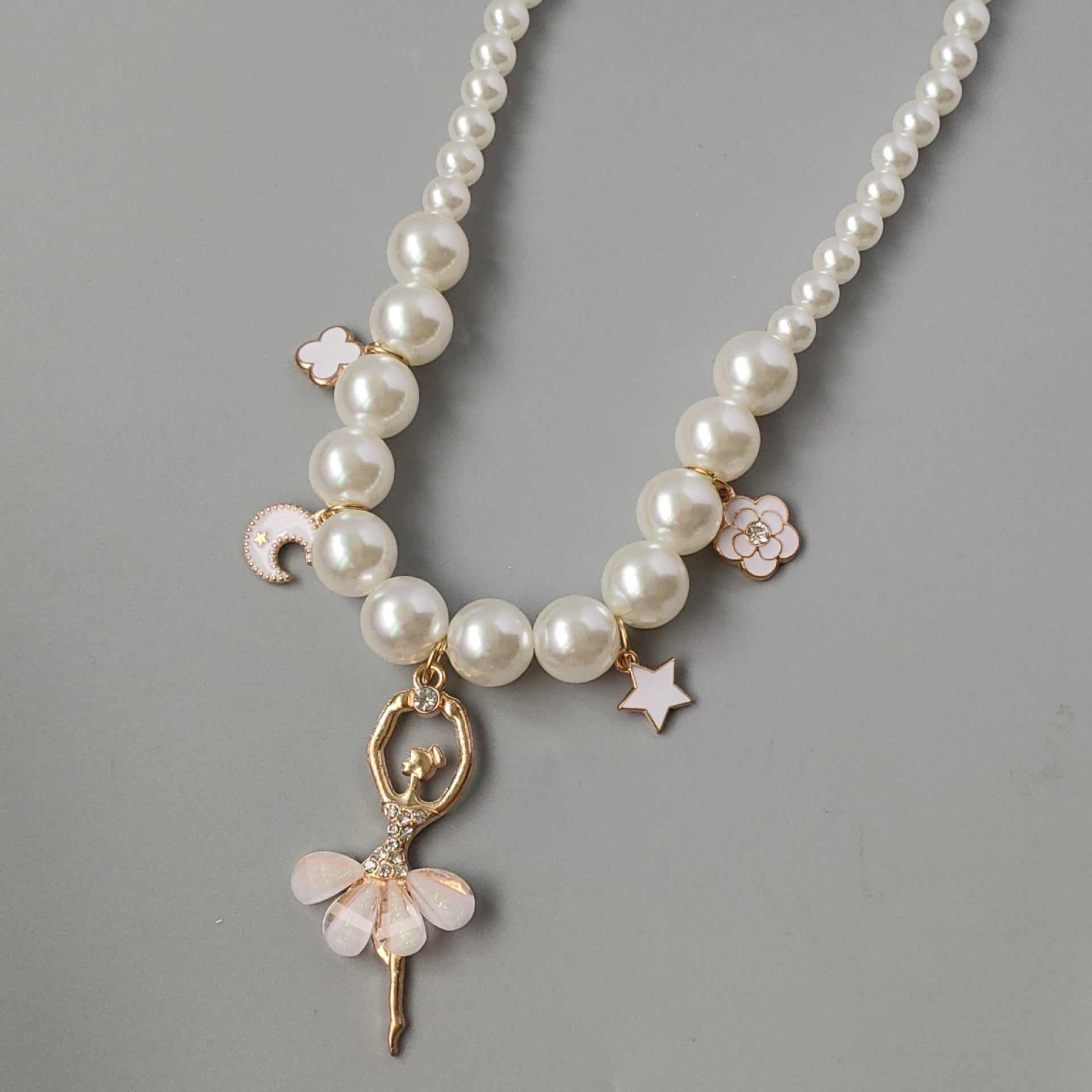 Korean style children's pearl necklace with ballerina charm, suitable for travel, holiday, birthday, party, and photography.